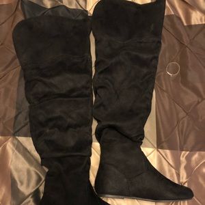Black thigh high boots.